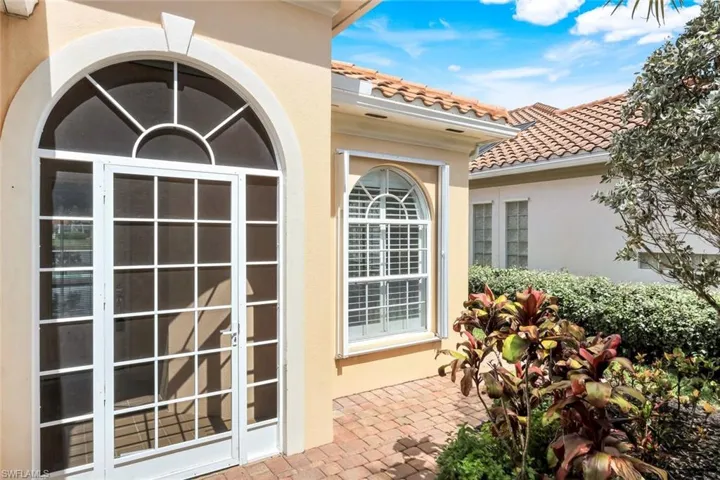 Exterior view of stucco siding and a tile roof