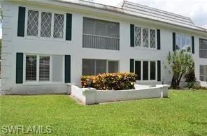 Back of house with a lawn