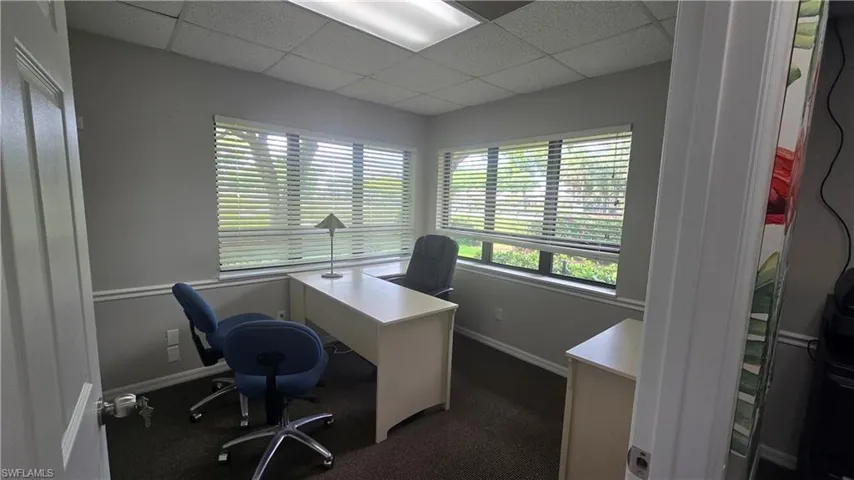 Office area featuring a drop ceiling and plenty of natural light