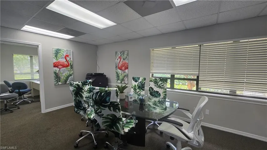 Office area featuring a drop ceiling and healthy amount of natural light