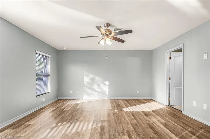 Primary Bedroom w/ wood flooring and ample space