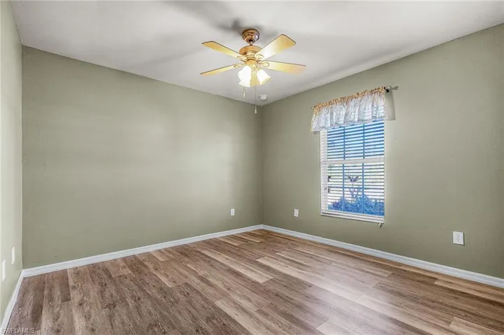 Unfurnished room w/ woo flooring
