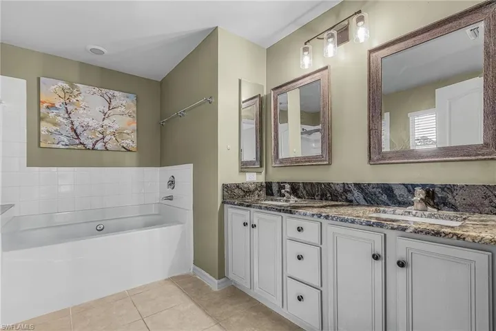 Bathroom with a dual vanity, large soaking tub and shower