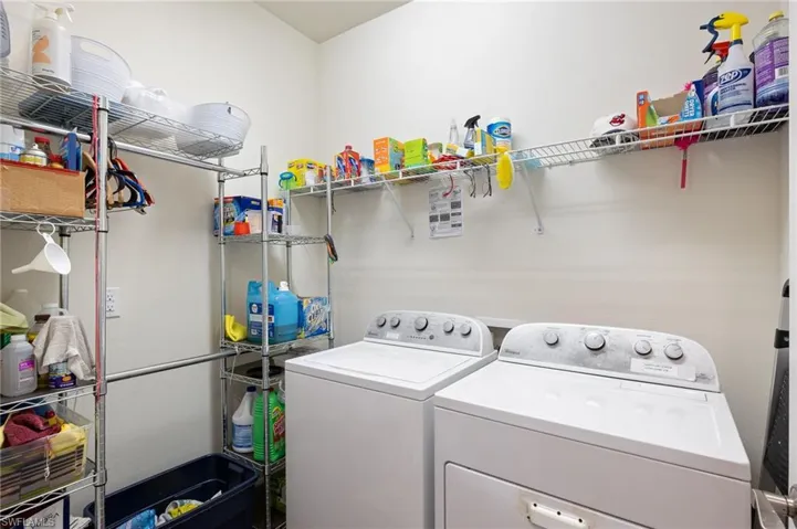 Laundry room with washer and clothes dryer