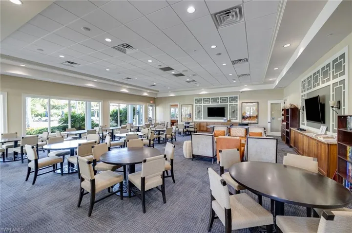 Dining area with recessed lighting, dark carpet, and a tray ceiling