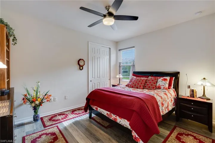 Bedroom featuring dark wood finished floors, a ceiling fan, and a closet
