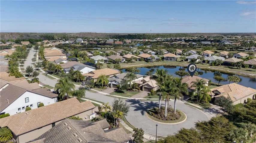 Aerial perspective of suburban area featuring a nearby body of water