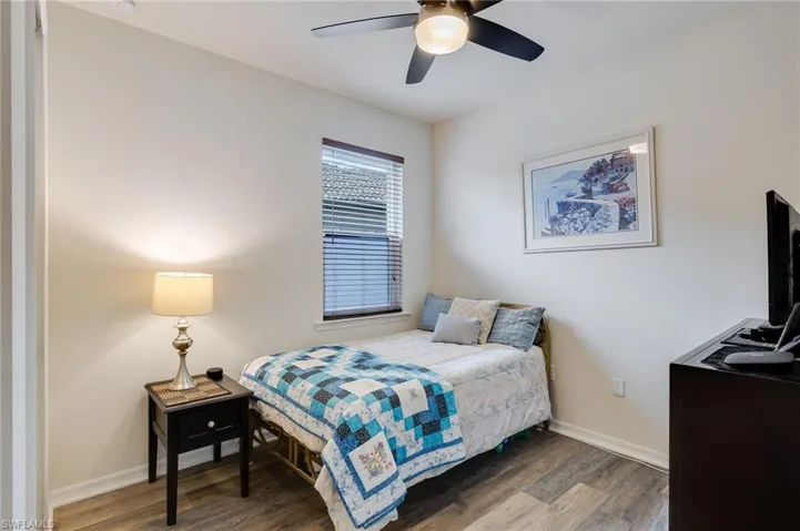 Bedroom with wood finished floors and ceiling fan