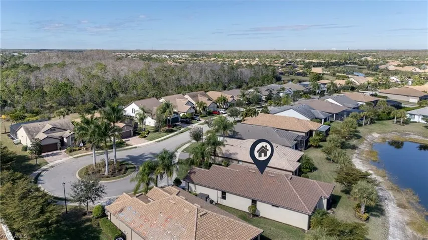 Aerial view of property's location with nearby suburban area