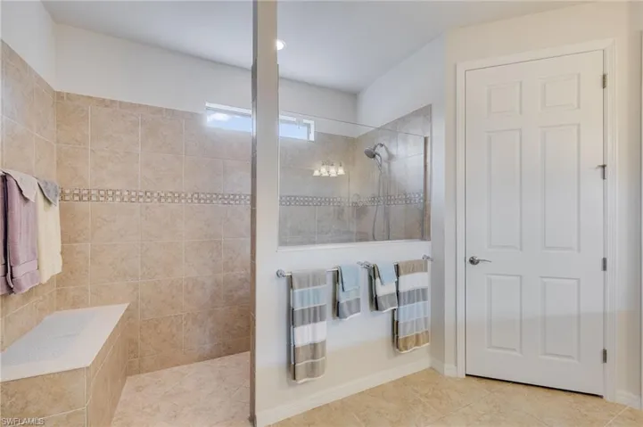 Full bath with walk in shower and tile patterned flooring