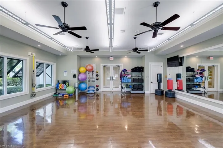 Exercise area with french doors and recessed lighting