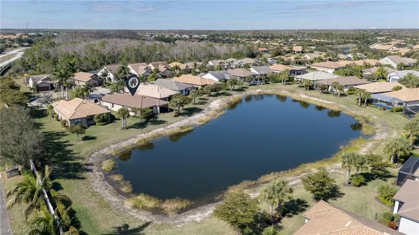 Aerial overview of property's location with nearby suburban area and a large body of water
