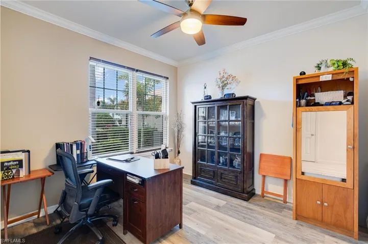 Office space with crown molding, light wood-type flooring, and ceiling fan