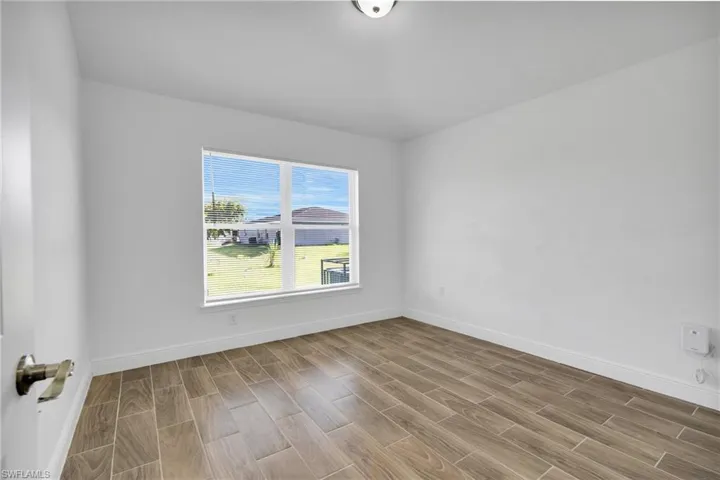 Unfurnished room with wood finish floors
