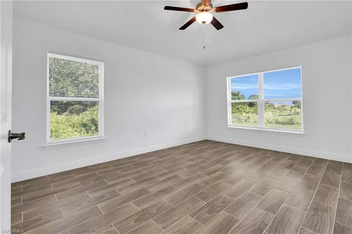 Empty room featuring a ceiling fan and wood finished floors