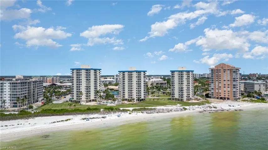 Birds eye view of property with a view of the beach and a water view