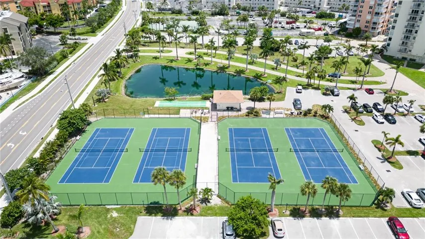Birds eye view of property with a water view