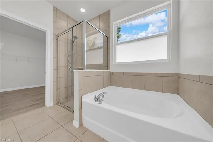 Tiled Walk-In Shower with Glass Enclosure and Soaking Tub