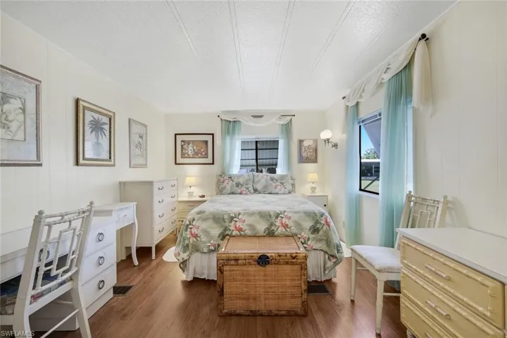Bedroom with dark wood finished floors and a textured ceiling