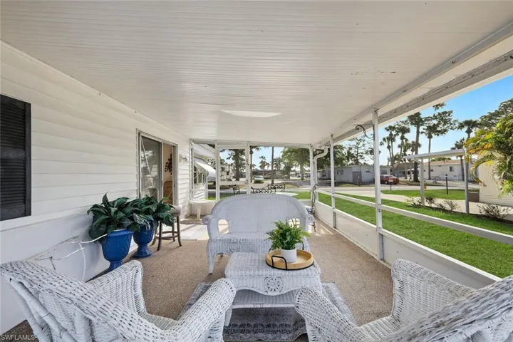 View of patio featuring a sunroom