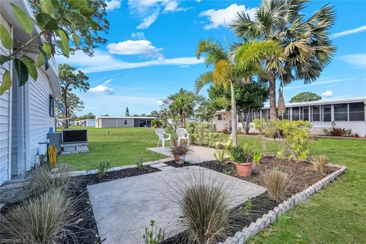 View of grassy yard featuring a patio area
