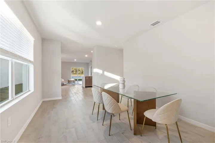 Dining space with baseboards, light wood-style flooring, and recessed lighting