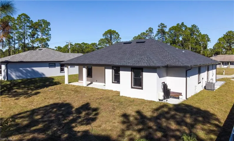 Back of house featuring a yard, a patio, and central air condition unit