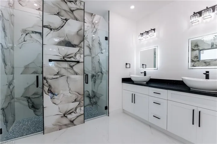 Bathroom with vanity and a shower with shower door