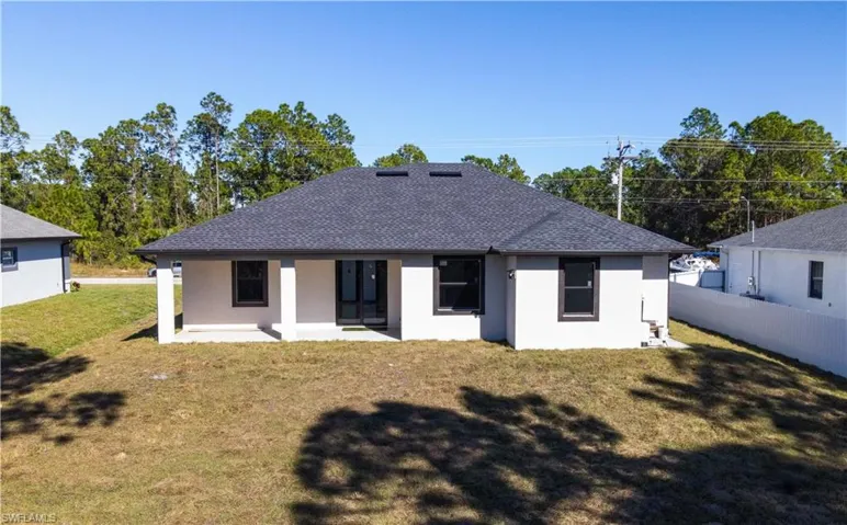 Back of property with a patio area and a yard