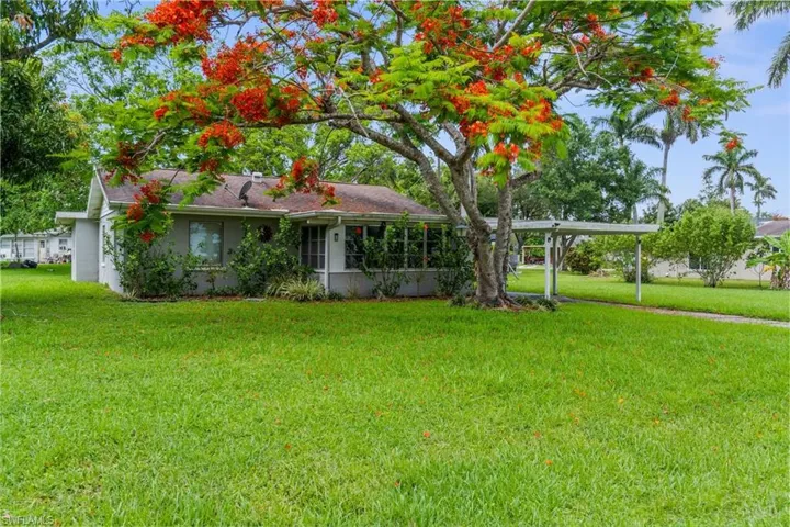 View of front of house featuring a front lawn and stucco siding