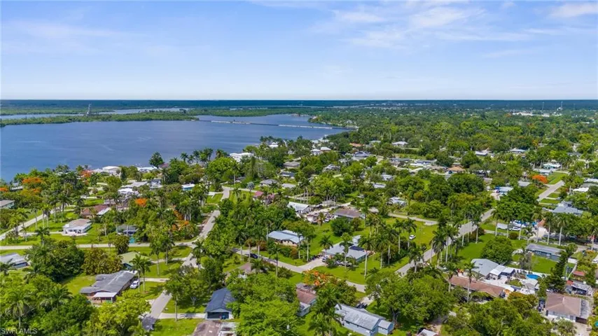 View of property location featuring a nearby body of water and nearby suburban area