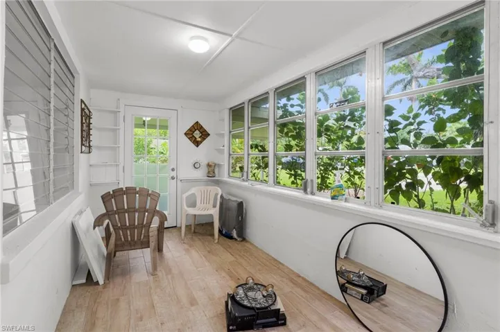 Sunroom with plenty of natural light and wood-type flooring