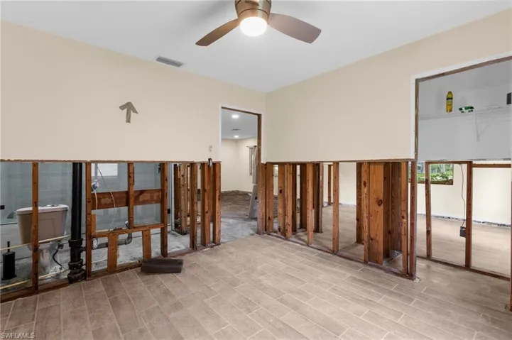 Unfurnished room with ceiling fan and light wood finished floors