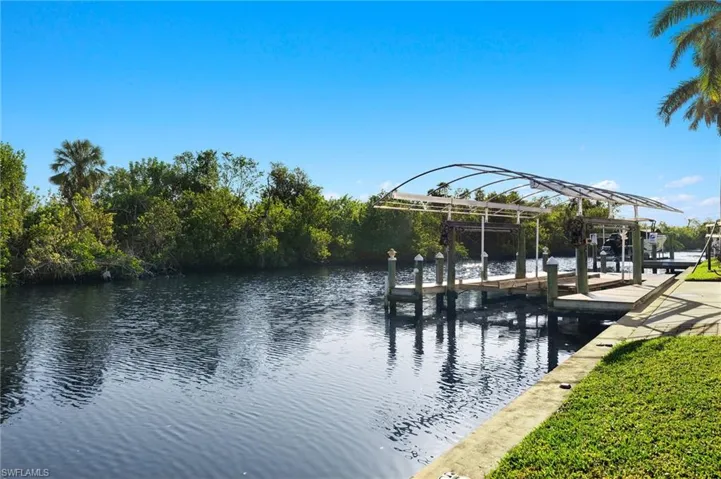 Dock area with a water view and boat lift