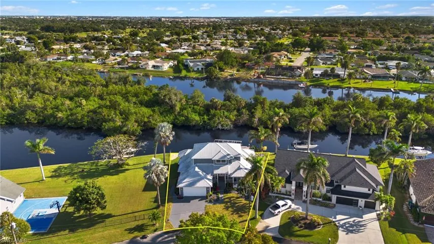 Aerial view of residential area featuring a large body of water