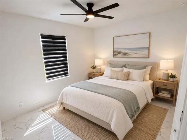 White walls, patterned flooring, and a ceiling fan with integrated lighting