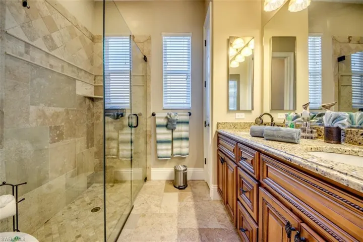 Bathroom featuring vanity and a shower with shower door