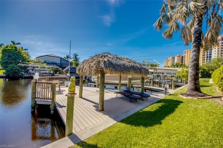 Dock area with a yard and a water view