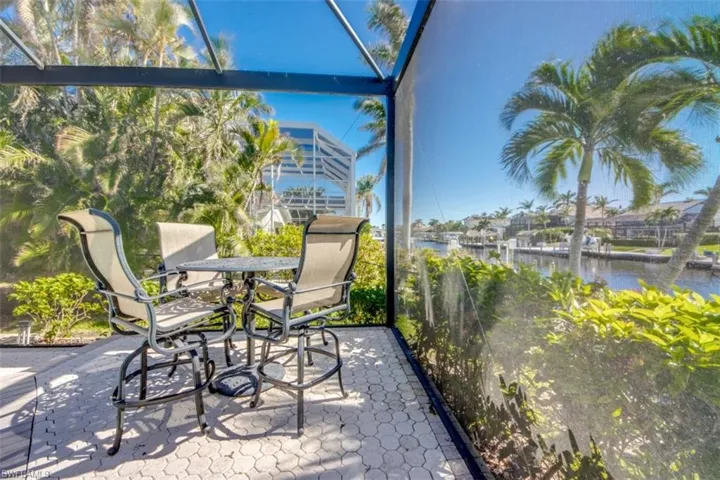 Sunroom featuring a water view