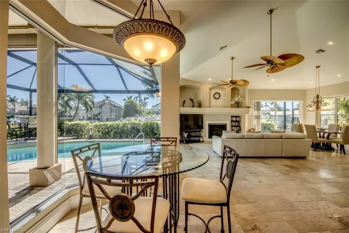 Dining space featuring a towering ceiling and ceiling fan