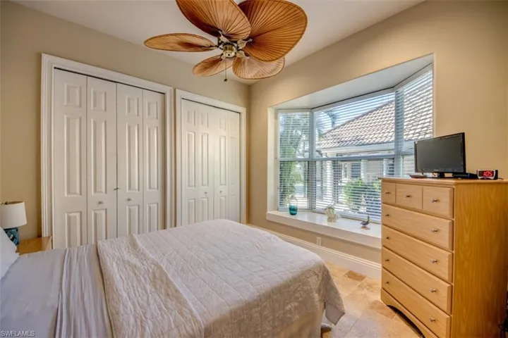 Bedroom featuring ceiling fan and two closets