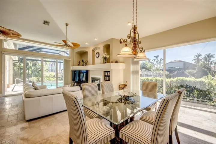 Dining space featuring a wealth of natural light, ceiling fan, and lofted ceiling