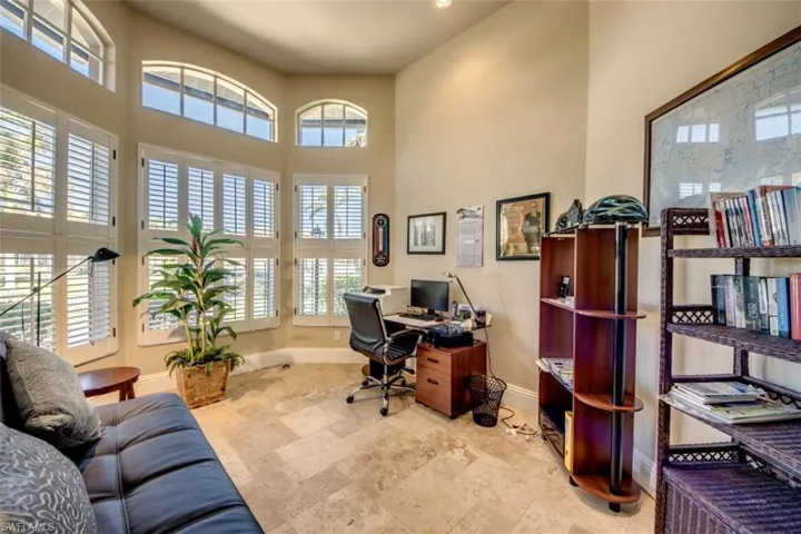Office space with plenty of natural light and a high ceiling