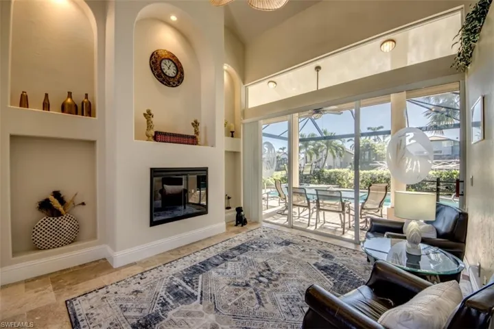 Living room with ceiling fan and a towering ceiling