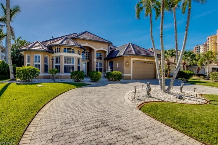 Mediterranean / spanish-style home featuring a garage and a front lawn