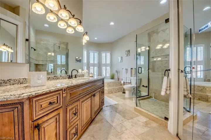 Bathroom with vanity and separate shower and tub