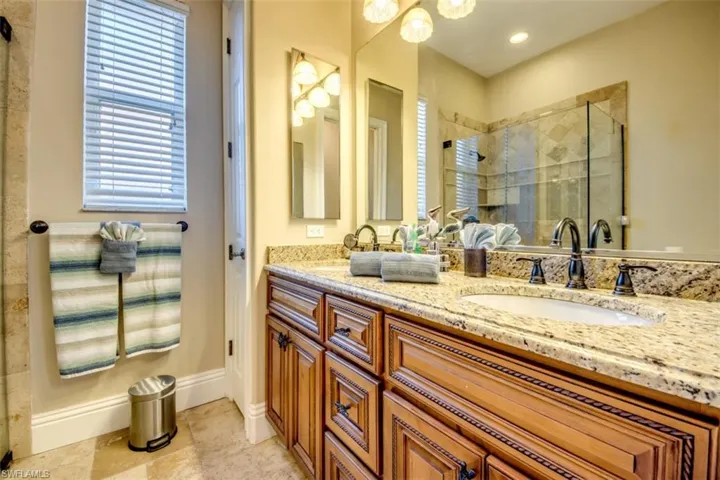 Bathroom featuring vanity and an enclosed shower