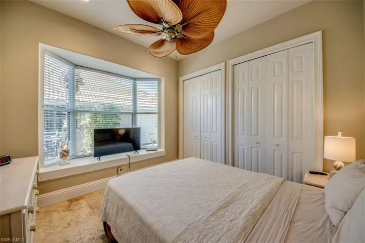 Bedroom with ceiling fan and two closets