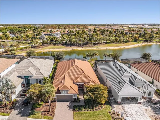 Aerial perspective of suburban area featuring a nearby body of water