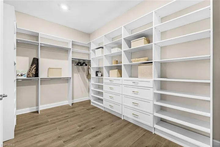 Walk in closet featuring light wood-style flooring